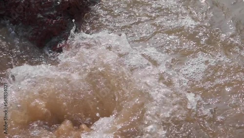 Wallpaper Mural Closeup shot of a rock being surrounded by the sea water due to the sea waves at Kakolem beach during the high tide at Goa in India. Sea water covers the rock at the shore of the beach. Torontodigital.ca