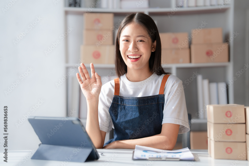 Attractive young mixed race chinese half thai ethnicity SME owners woman entrepreneurs working on receipt box and check online orders, SME home business ideas online. Attractive young mixed race chinese half thai ethnicity SME owners woman entrepreneurs working on receipt box and check online orders, SME home business ideas online.