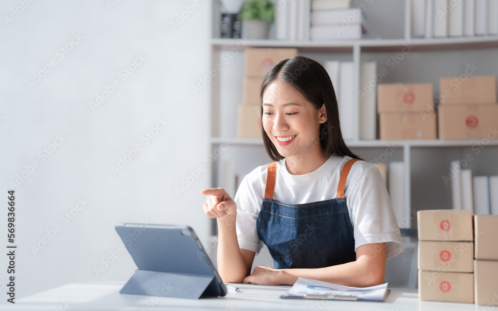 Attractive young mixed race chinese half thai ethnicity SME owners woman entrepreneurs working on receipt box and check online orders, SME home business ideas online. Attractive young mixed race chinese half thai ethnicity SME owners woman entrepreneurs working on receipt box and check online orders, SME home business ideas online.