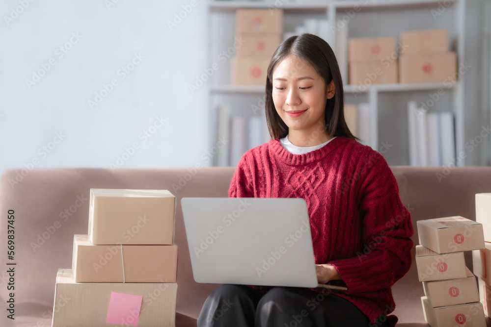 Attractive young mixed race chinese half thai ethnicity SME owners woman entrepreneurs working on receipt box and check online orders, SME home business ideas online. Attractive young mixed race chinese half thai ethnicity SME owners woman entrepreneurs working on receipt box and check online orders, SME home business ideas online.