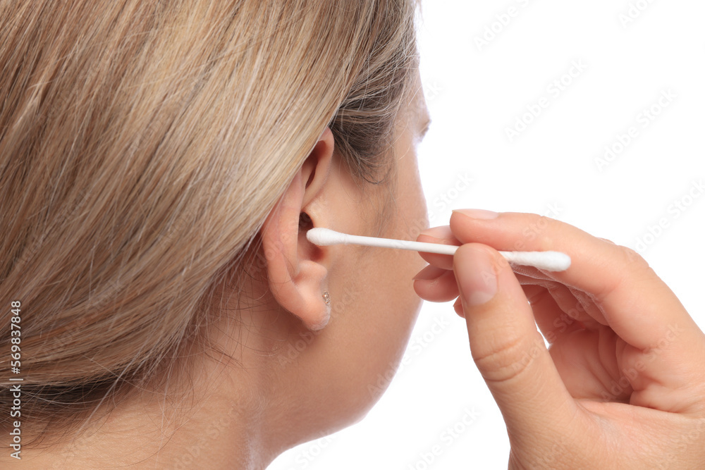Young woman cleaning ear with cotton swab on white background, closeup Young woman cleaning ear with cotton swab on white background, closeup