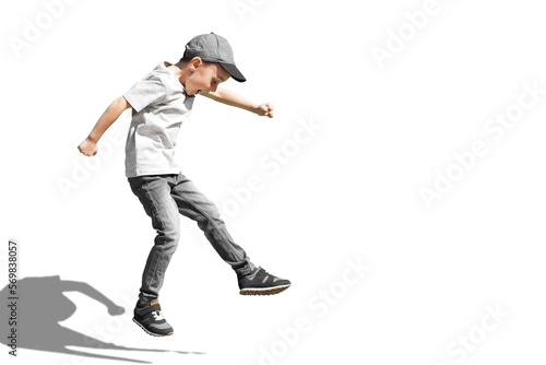 a Young boy runs in the jump on the street on a bright blue background
