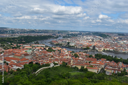 Old town of Prague. Czech Republic over river Vltava with Charles Bridge on skyline. Prague panorama landscape view with red roofs.