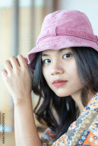 Close up horizontal front portrait of attractive young Asian woman with serious expression on face. Beautiful woman in portrait, smiling