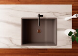 Top down view of kitchen sink. Stainless matte grey sink, black faucet, marble counter, wooden floor.