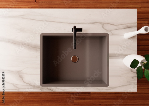 Top down view of kitchen sink. Stainless matte grey sink, black faucet, marble counter, wooden floor.