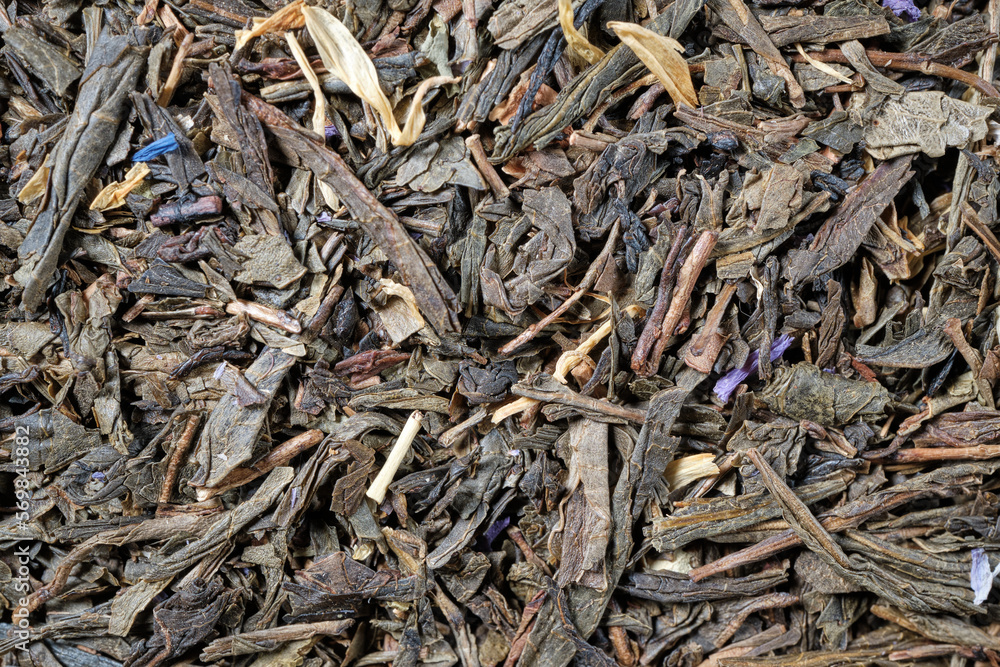 Background of green tea blend with natural additives. Close-up. Top view. Space for lettering and design. Background of green tea blend with natural additives. Close-up. Top view. Space for lettering and design.