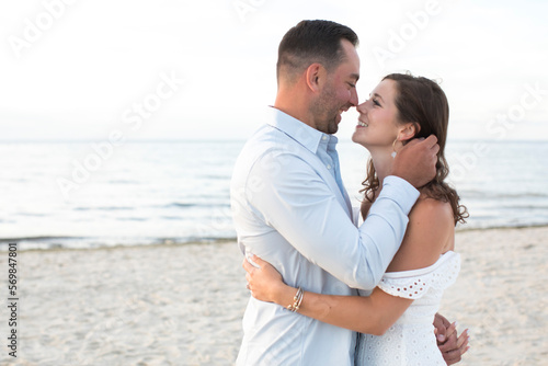 romantic couple embracing and looking at each other smiling