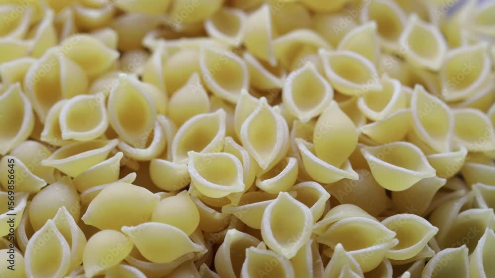 natural pasta in the shape of a shell close-up rotate in a circle natural pasta in the shape of a shell close-up rotate in a circle