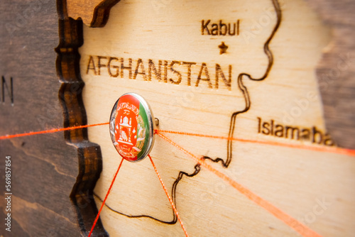 Afghanistan flag pins and red thread for traveling and planning trips. Planning of logistics routes or spheres of influence in geopolitics photo