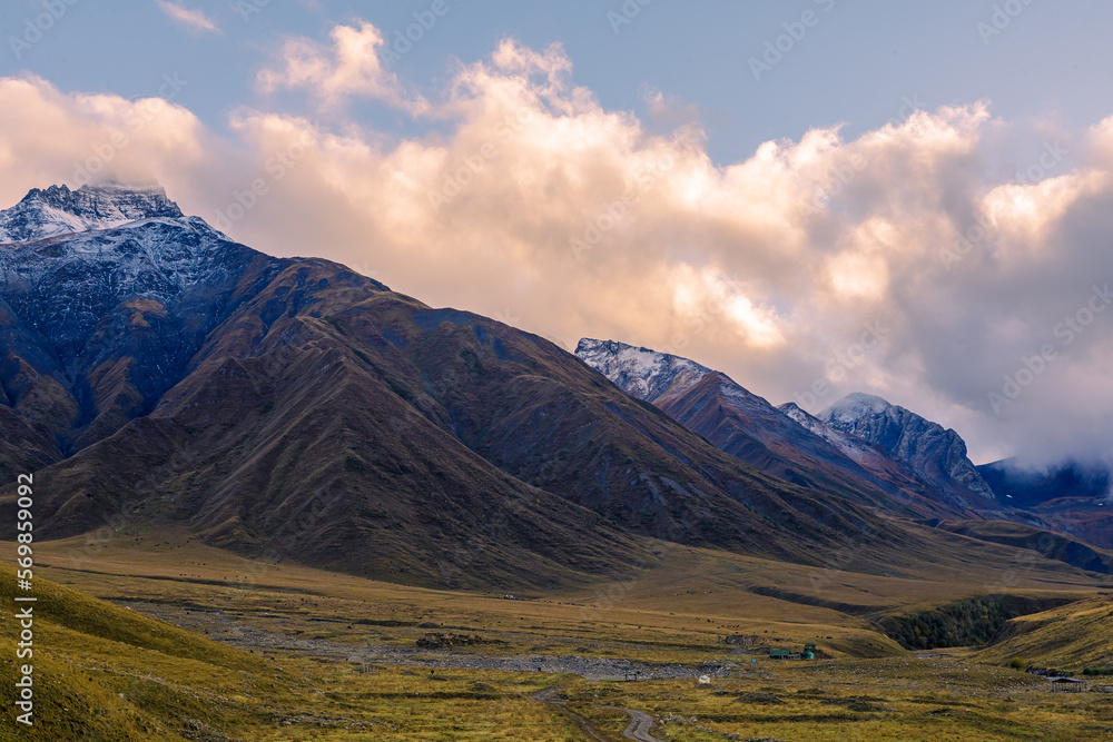 Highlands of North Ossetia. Mountains of the Caucasus. High mountains in the rays of the setting sun.