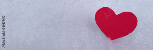 Banner on theme of romantic travel and walks in winter with place for text. Valentine's day page. White snowy background with heart shaped valentine. Copy space. Header with place for slogan, title.