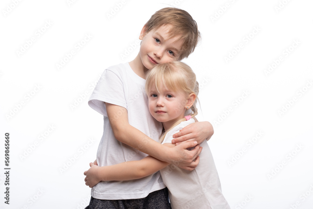 Portrait of a child, the love of brother and sister in his arms on a white background Portrait of a child, the love of brother and sister in his arms on a white background