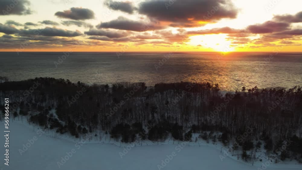 Slow pan across the horizon of lake Michigan during a Winter sunset. Slow pan across the horizon of lake Michigan during a Winter sunset.