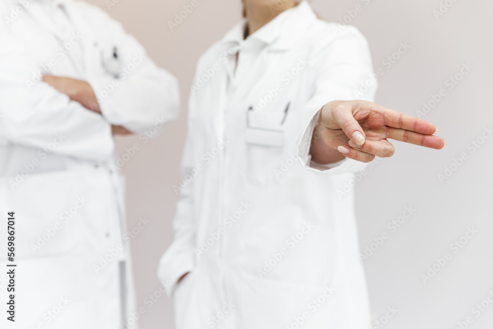 doctor wiping with a finger, space for interactive themes, female doctor in the background doctor wiping with a finger, space for interactive themes, female doctor in the background