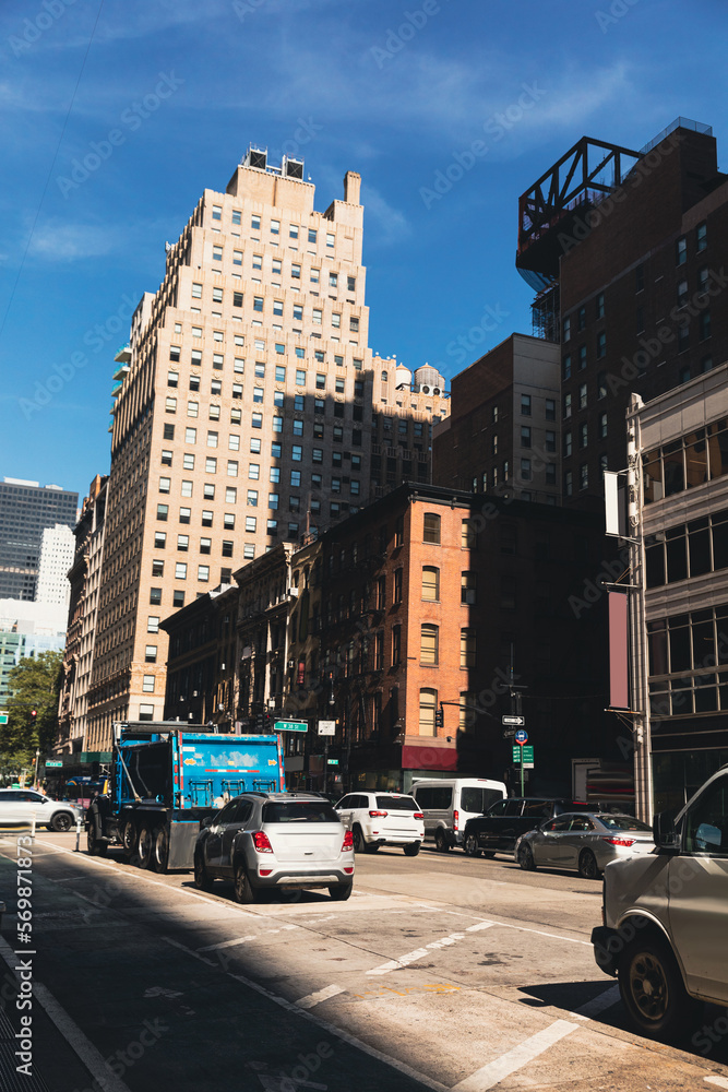 NEW YORK, USA - OCTOBER 13, 2022: cars and garbage truck on road on sunny day NEW YORK, USA - OCTOBER 13, 2022: cars and garbage truck on road on sunny day