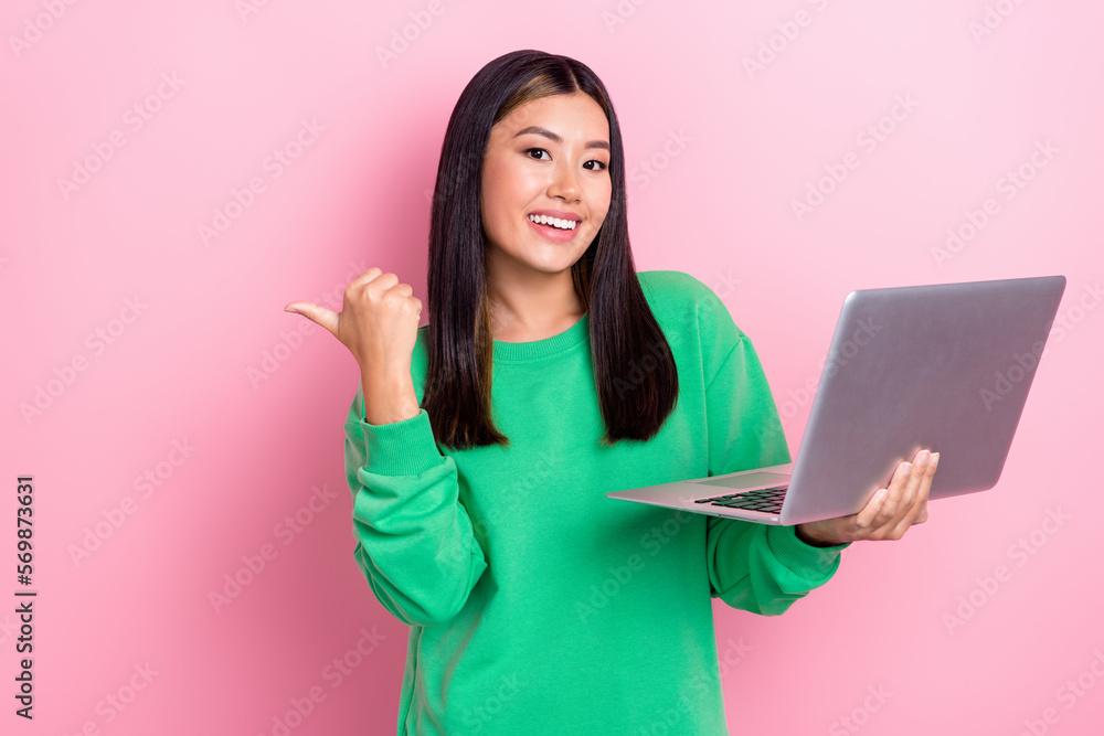 Photo of sweet shiny girl dressed green sweatshirt typing modern gadget thumb empty space isolated pink color background Photo of sweet shiny girl dressed green sweatshirt typing modern gadget thumb empty space isolated pink color background