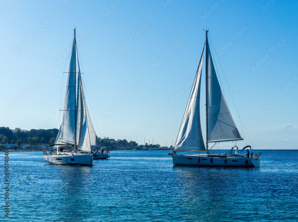 boats and yachts at the sailing regatta on open water. Sailing on the wind waves in the sea.