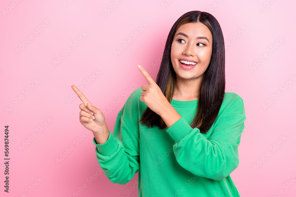 Photo of excited cheerful japanese lady look satisfied interesting option new gym opening point fingers copyspace ad isolated on pink color background Photo of excited cheerful japanese lady look satisfied interesting option new gym opening point fingers copyspace ad isolated on pink color background