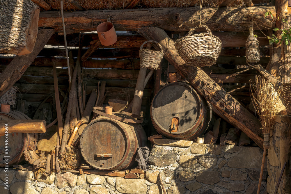 rustic stil life in old traditional vintage style with barrels , bottles and baskets , vintage wooden vinery , paesant background