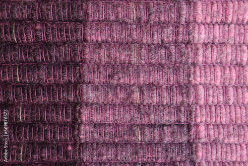 Shades of violet wool yarn cloth abstract background. Surface of fabric texture in violet and purple.