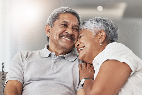 Love, relax and senior couple laugh at funny joke, enjoy quality time together and bond on home living room sofa. Retirement, smile and elderly man, woman or people happy in Rio de Janeiro Brazil photo