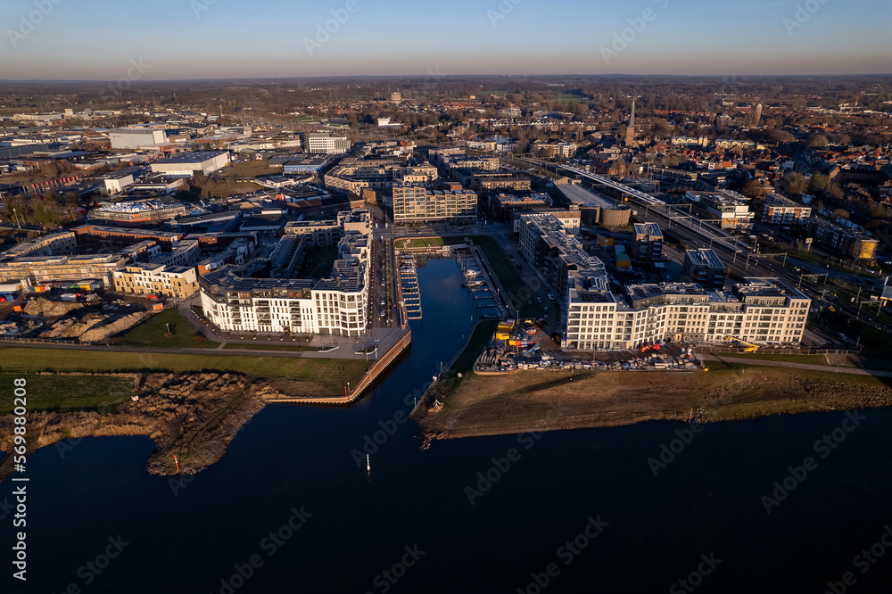 Obraz premium Noorderhaven neighbourhood at riverbed of the IJssel in Zutphen, The Netherlands, under construction. Aerial panorama industrial view of building plot. Housing and urban management real estate.
