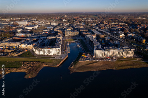 Noorderhaven neighbourhood at riverbed of the IJssel in Zutphen, The Netherlands, under construction. Aerial panorama industrial view of building plot. Housing and urban management real estate. photo