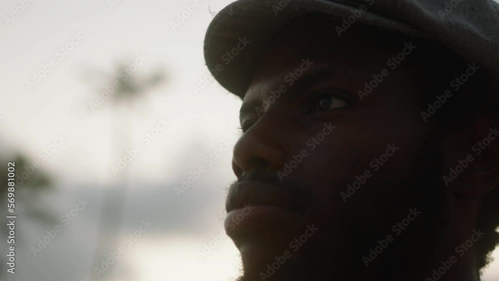 Close-up of a young black man on an exotic beach with palm trees in the background. High quality 4k footage. Close-up of a young black man on an exotic beach with palm trees in the background. High quality 4k footage.