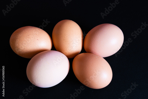 Five colored eggs on a black background