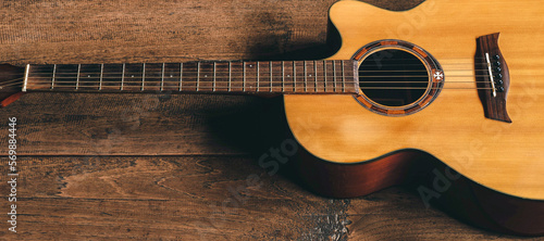 Top view of classical guitar on old wooden background.dark tone