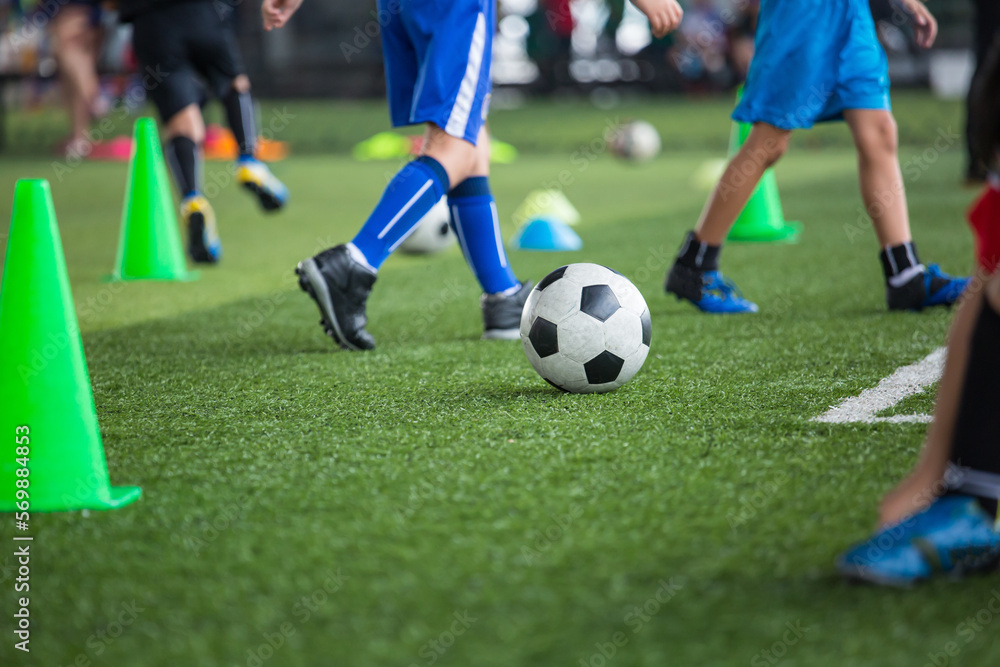 Boys Soccer ball tactics on grass field with cone Boys Soccer ball tactics on grass field with cone