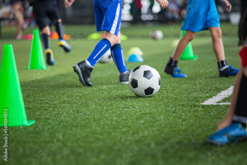 Fototapeta Naklejka Na Ścianę i Meble -   Boys Soccer ball tactics on grass field with cone