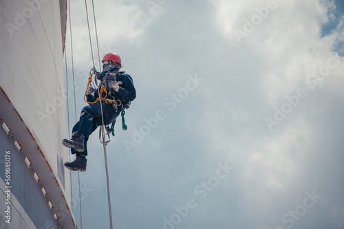 Male worker rope access  inspection of thickness  storage tank photo