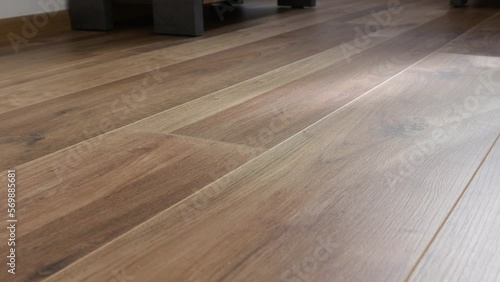 New laminate flooring. Laminated parquet with brown wooden texture