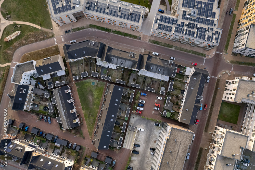 Top down view of residential complex seen from above with roof full of solar panels in urban development of real estate investment project. Aerial housing, Dutch architecture and engineering concept