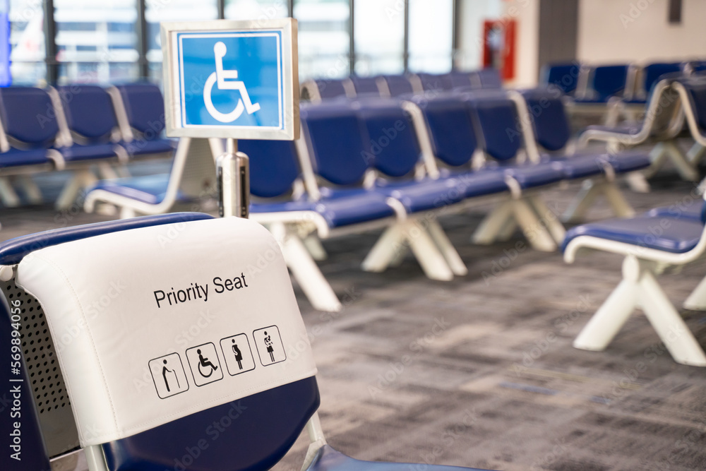 Fototapeta premium Close-up of a chair in an airport seat, a passenger's special seat. Empty metal chair in the airport waiting room furniture pictures Airport departure or arrival concept image