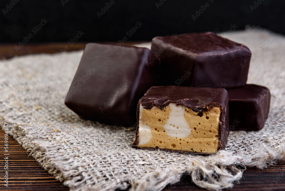 Chocolate candies souffle Tiramisu on dark wooden background.