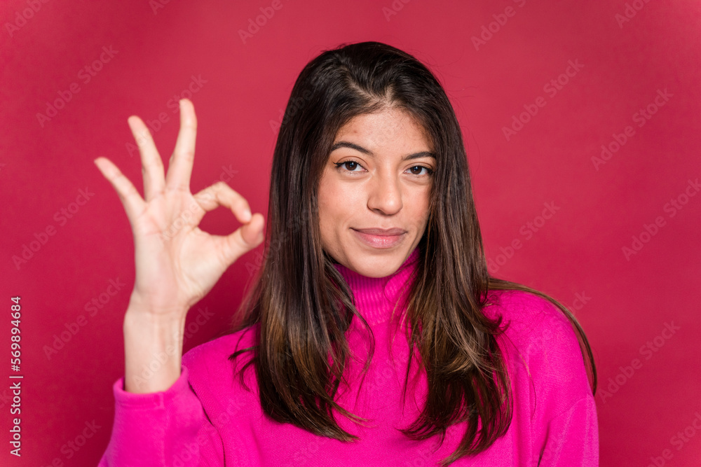 Smiling woman showing OK gesture Smiling woman showing OK gesture