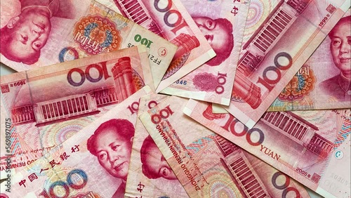 Paper money in denominations of 100 yuan are laid out in a circle on a light table. Chinese economy and finance. Currency background. The concept of finance, banking, investment, business and lending photo