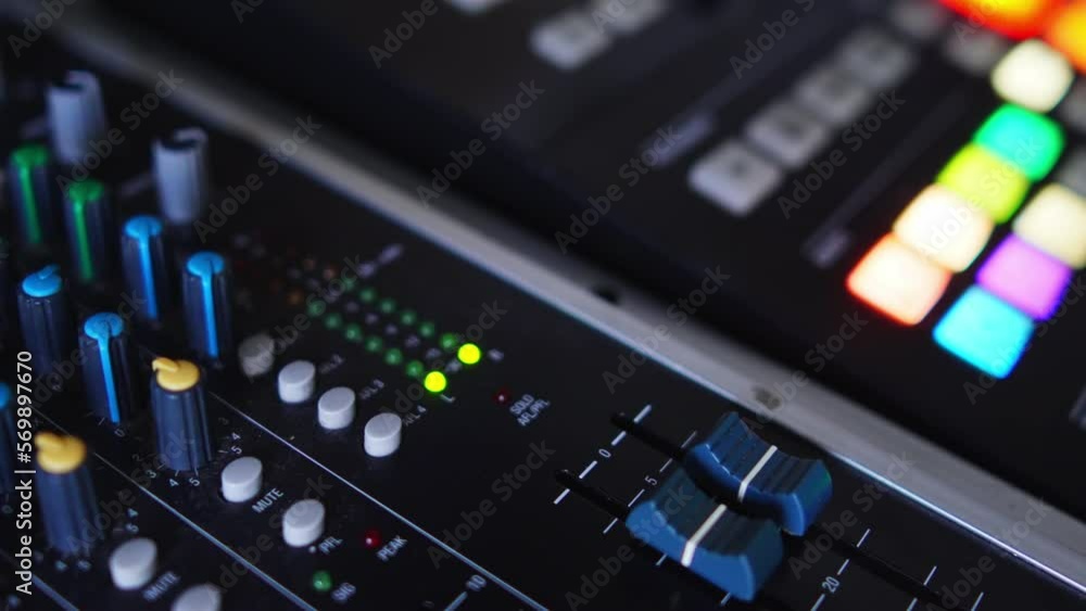 DJ audio mixing console with buttons lighten up during music recording. High quality 4k footage DJ audio mixing console with buttons lighten up during music recording. High quality 4k footage