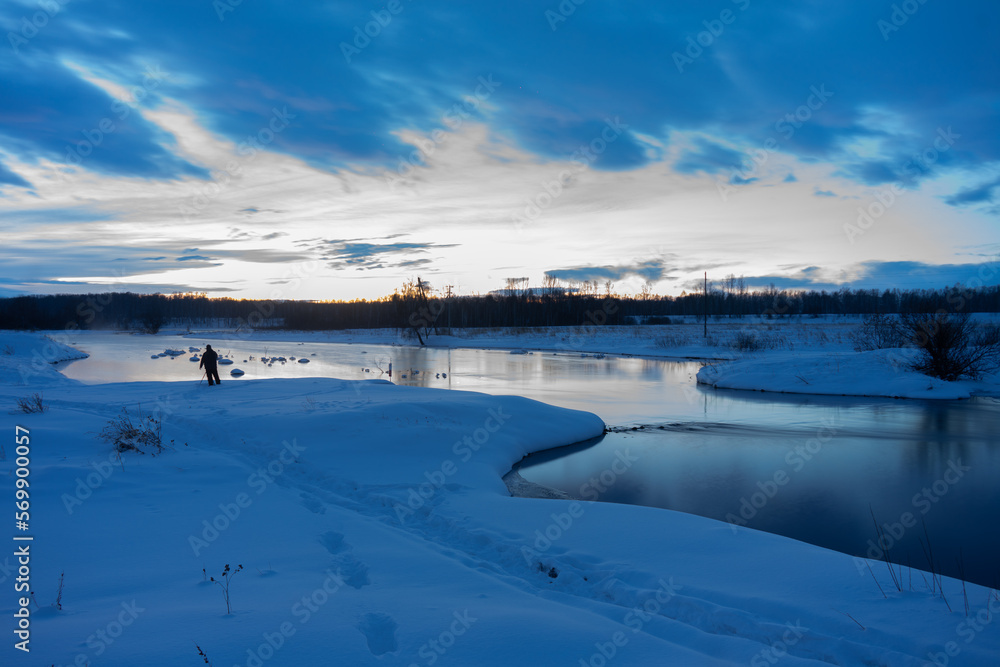 Morning, winter landscape of an unfrozen river on a long exposure