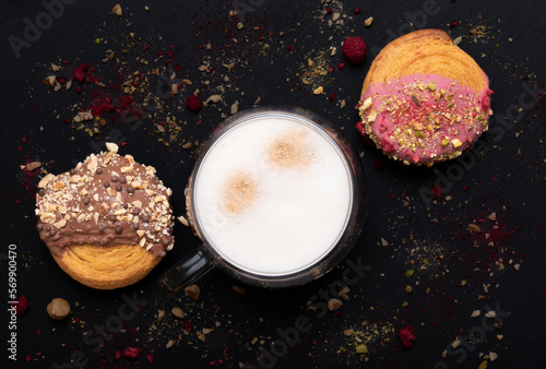 cappuccino with many layers of coffee  milk and foam and croissants on black background. Image from above