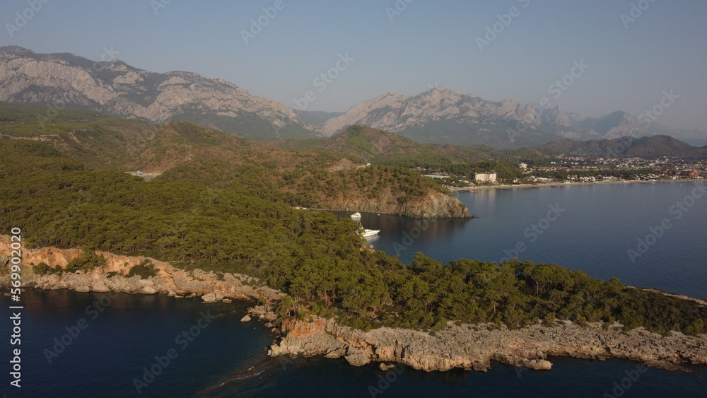 A bay Cennet Koyu with a Tahtalı Dagi mountain and Kemer view from a drone. 