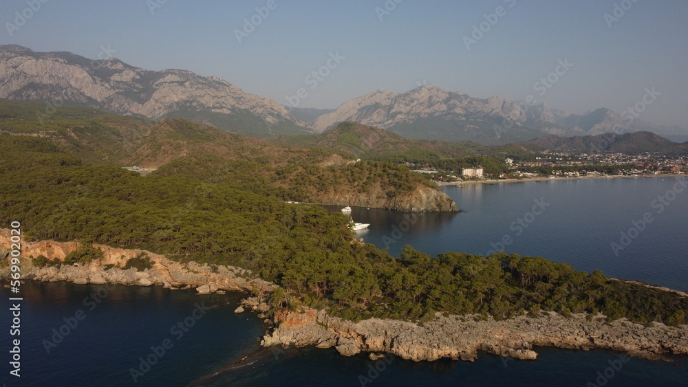 A bay Cennet Koyu with a Tahtalı Dagi mountain and Kemer view from a drone. A bay Cennet Koyu with a Tahtalı Dagi mountain and Kemer view from a drone.