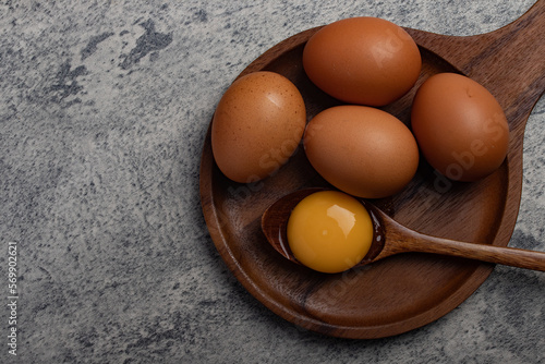 Fresh chicken eggs in a wooden plate