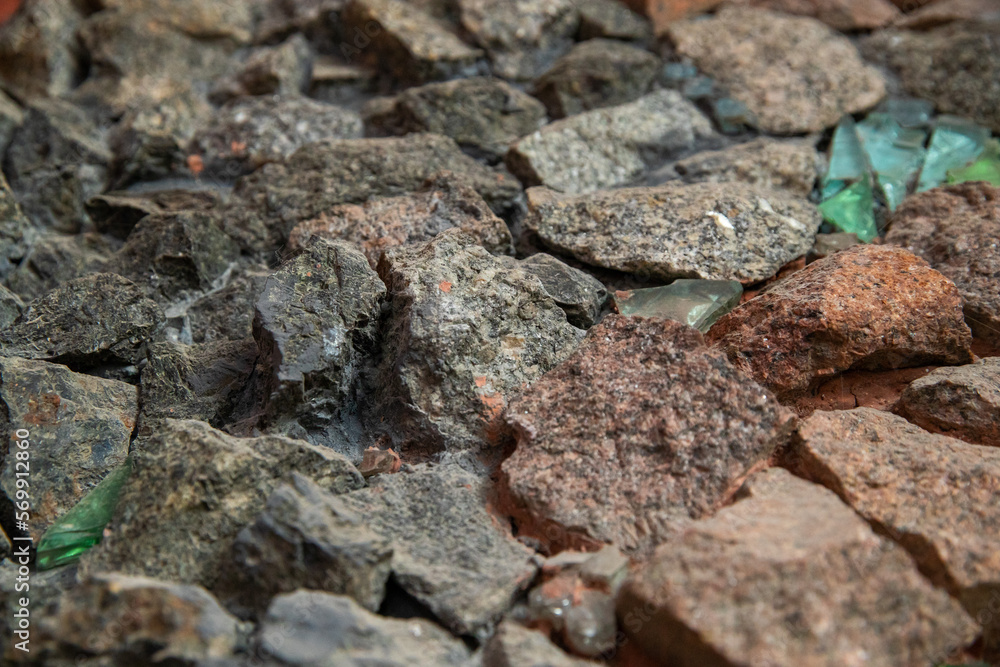 Stone patterns on the wall. Multi-colored marble stones. Structure of an old destroyed wall for a vintage closeup. Stone patterns on the wall. Multi-colored marble stones. Structure of an old destroyed wall for a vintage closeup.