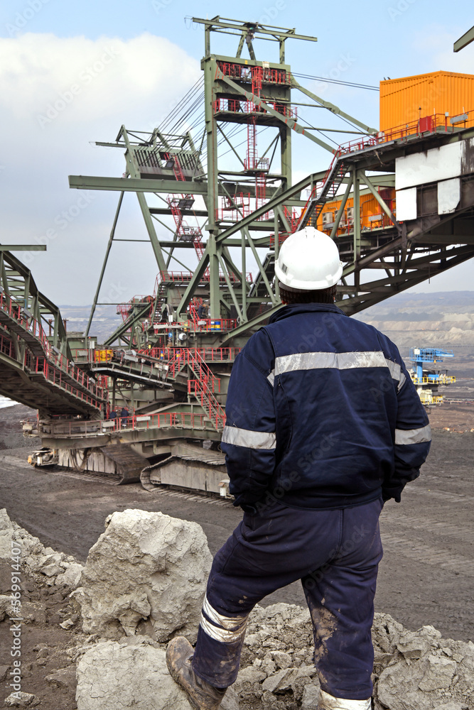 Bucket-wheel excavator during excavation at the surface mine. Huge excavator on open pit mine. Bucket-wheel excavator during excavation at the surface mine. Huge excavator on open pit mine.