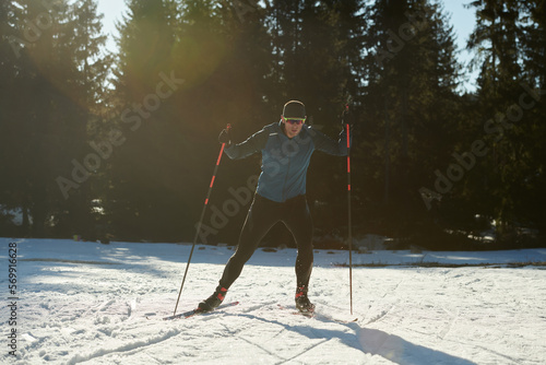 Nordic skiing or Cross-country skiing classic technique practiced by man in a beautiful panoramic trail at morning.Selective focus.
