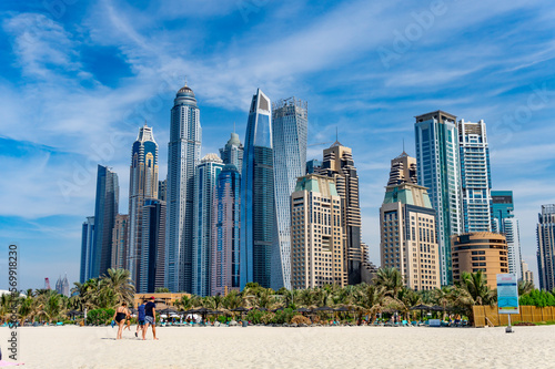 Photography Dubai skyscraper skyline with palm trees and the sand of the beach